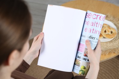 Photo of Woman reading magazine indoors, closeup. Mockup for design