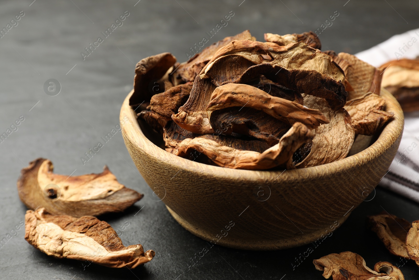 Photo of Dried chanterelle mushrooms on wooden table, closeup