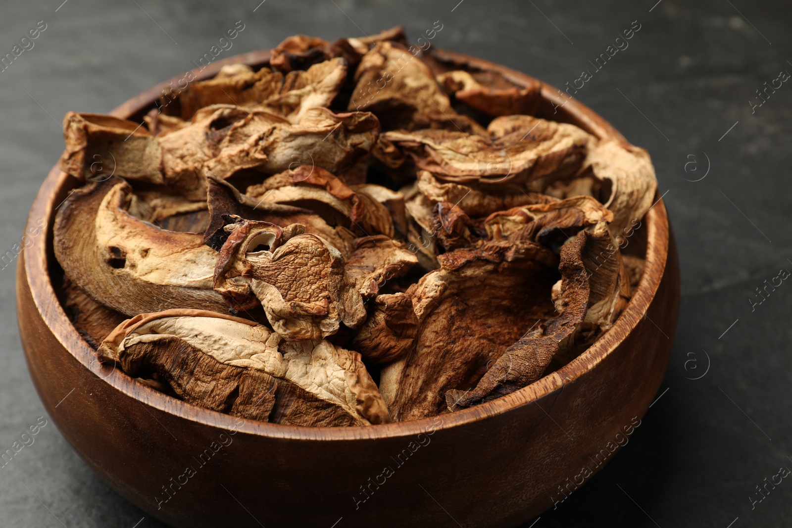 Photo of Dried chanterelle mushrooms on wooden table, closeup