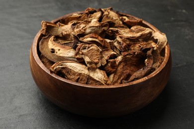 Photo of Dried chanterelle mushrooms on wooden table, closeup