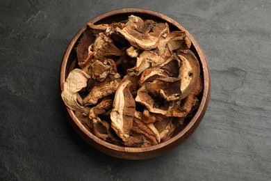 Photo of Dried chanterelle mushrooms on wooden table, top view