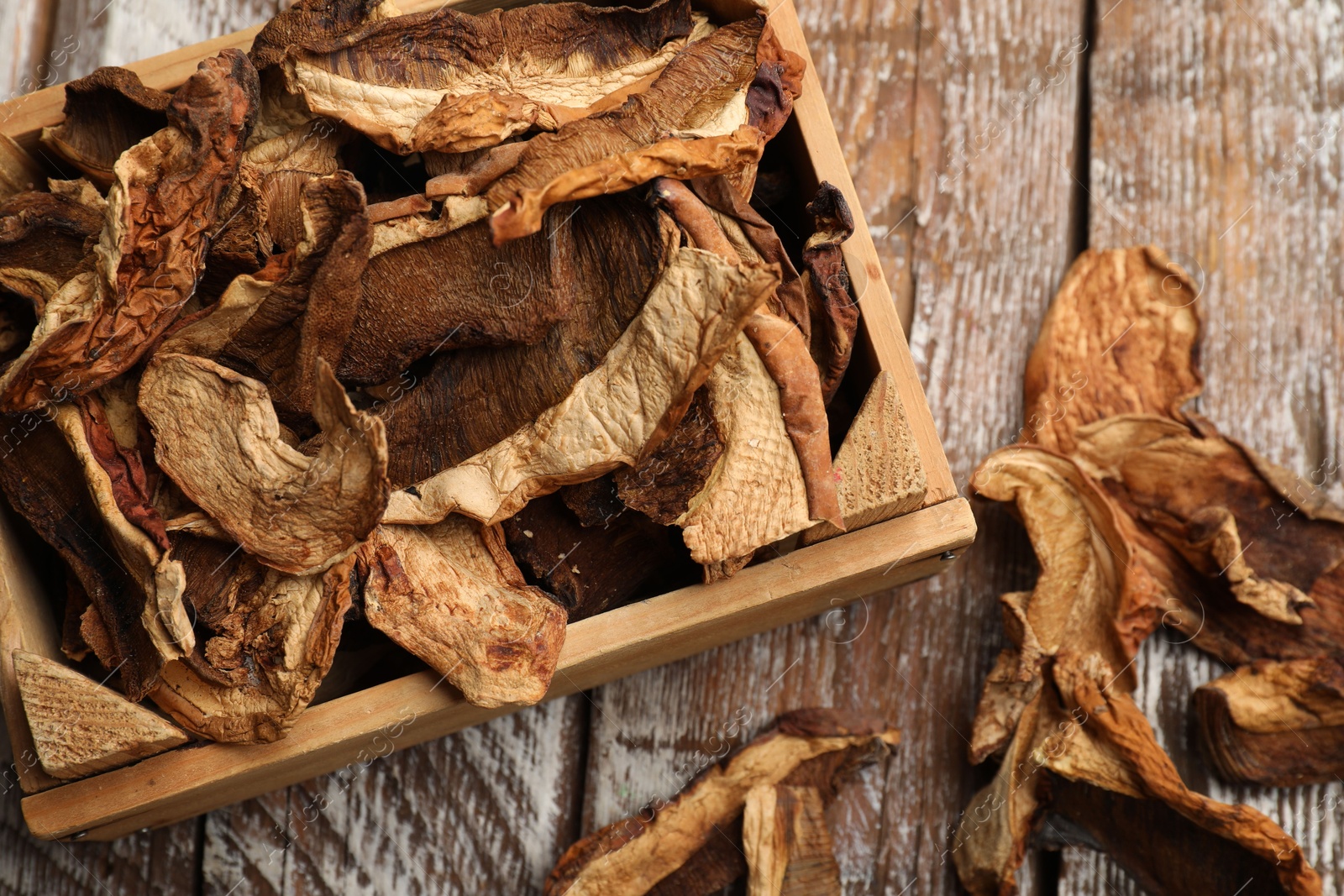 Dried chanterelle mushrooms on wooden table, flat lay Photo of Dried chanterelle mushrooms on wooden table, flat lay