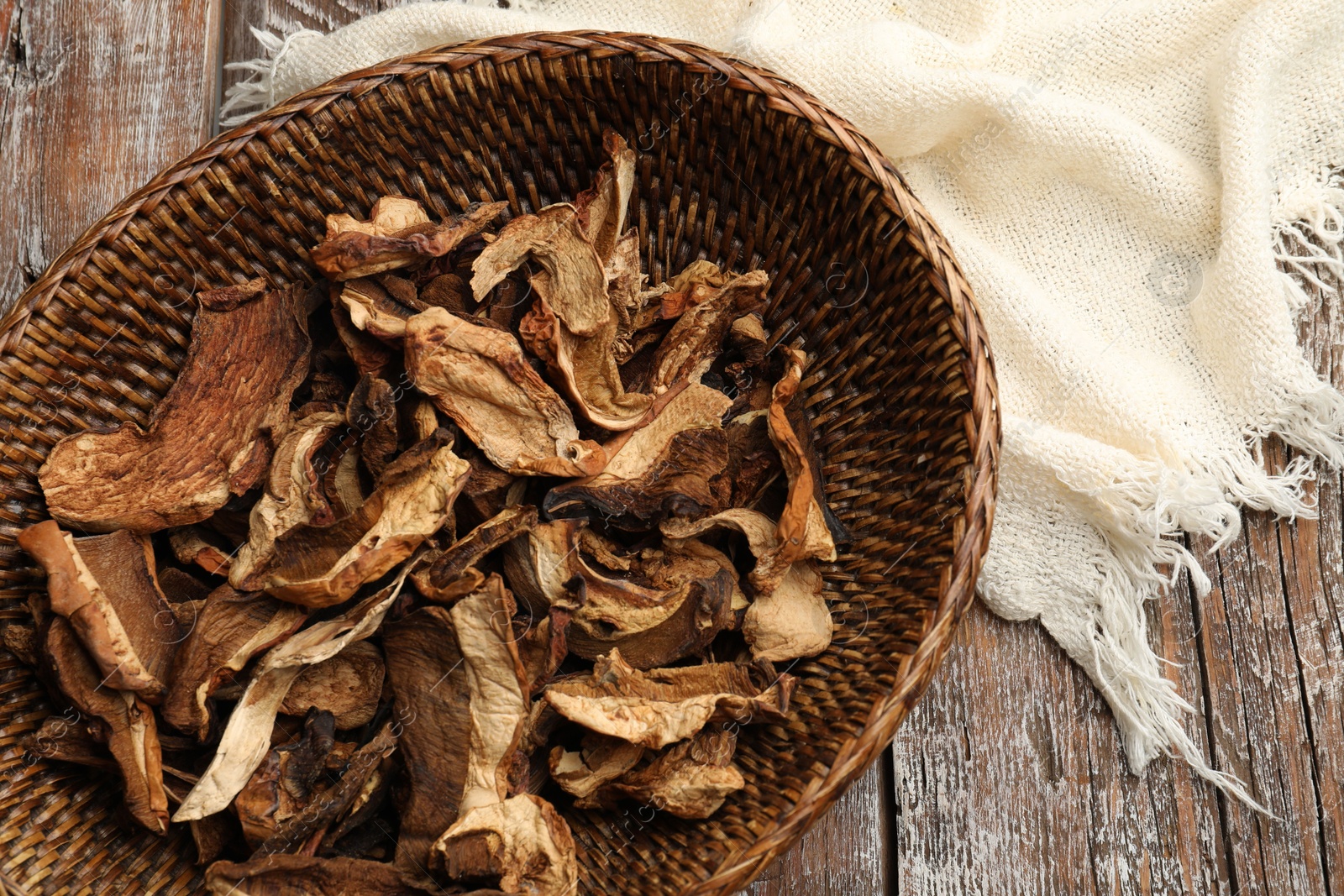 Dried chanterelle mushrooms on wooden table, top view Photo of Dried chanterelle mushrooms on wooden table, top view