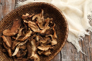 Photo of Dried chanterelle mushrooms on wooden table, top view