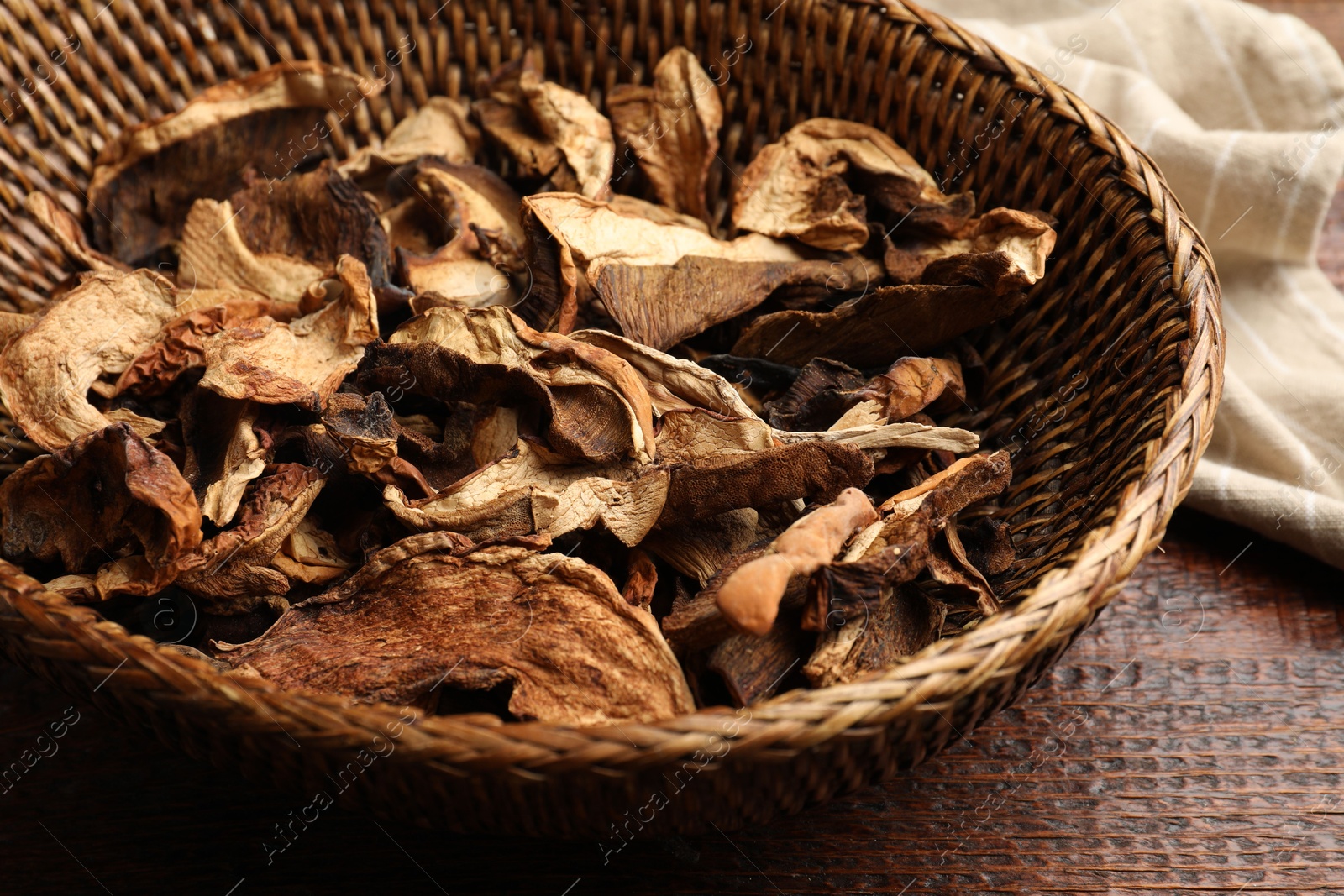 Photo of Dried chanterelle mushrooms on wooden table, closeup