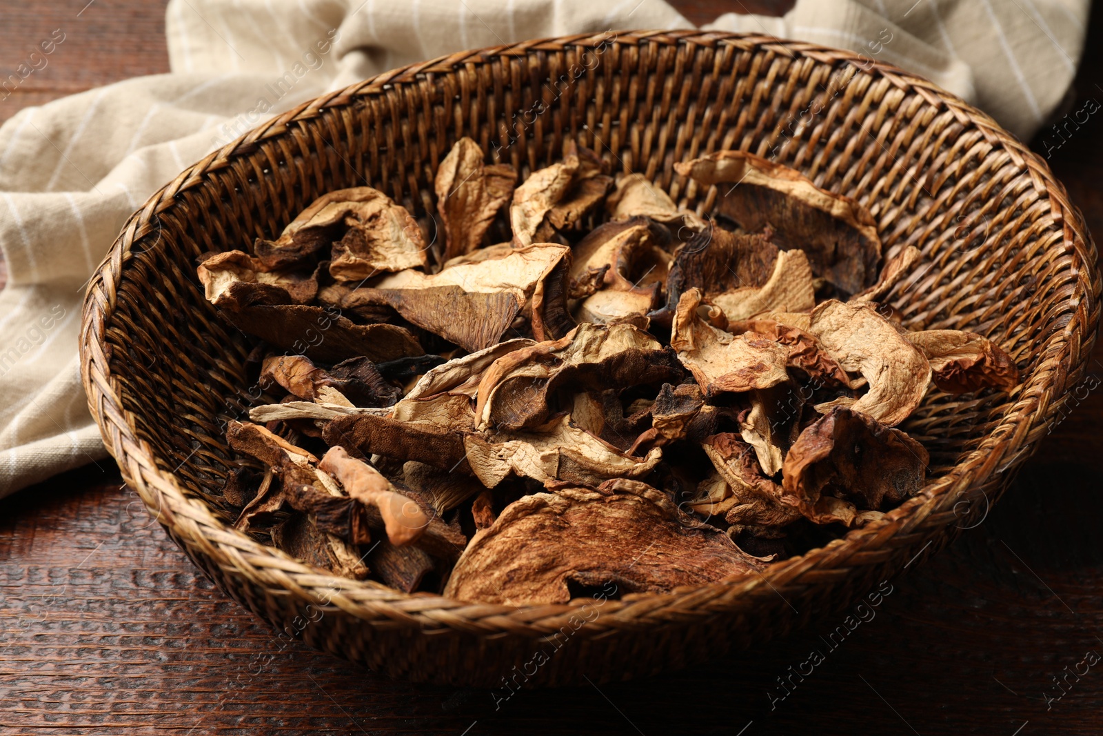 Photo of Dried chanterelle mushrooms on wooden table, closeup