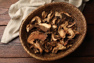 Photo of Dried chanterelle mushrooms on wooden table, top view