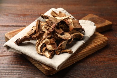 Photo of Dried chanterelle mushrooms on wooden table, closeup