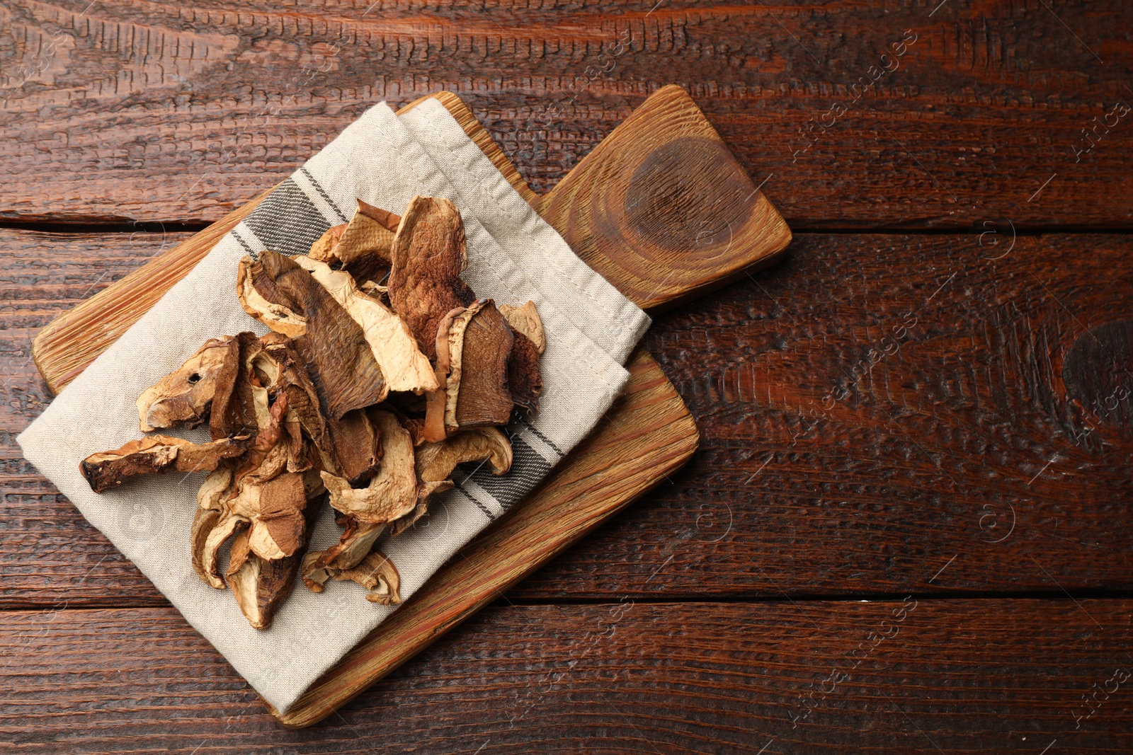 Dried chanterelle mushrooms on wooden table, top view. Space for text Photo of Dried chanterelle mushrooms on wooden table, top view. Space for text