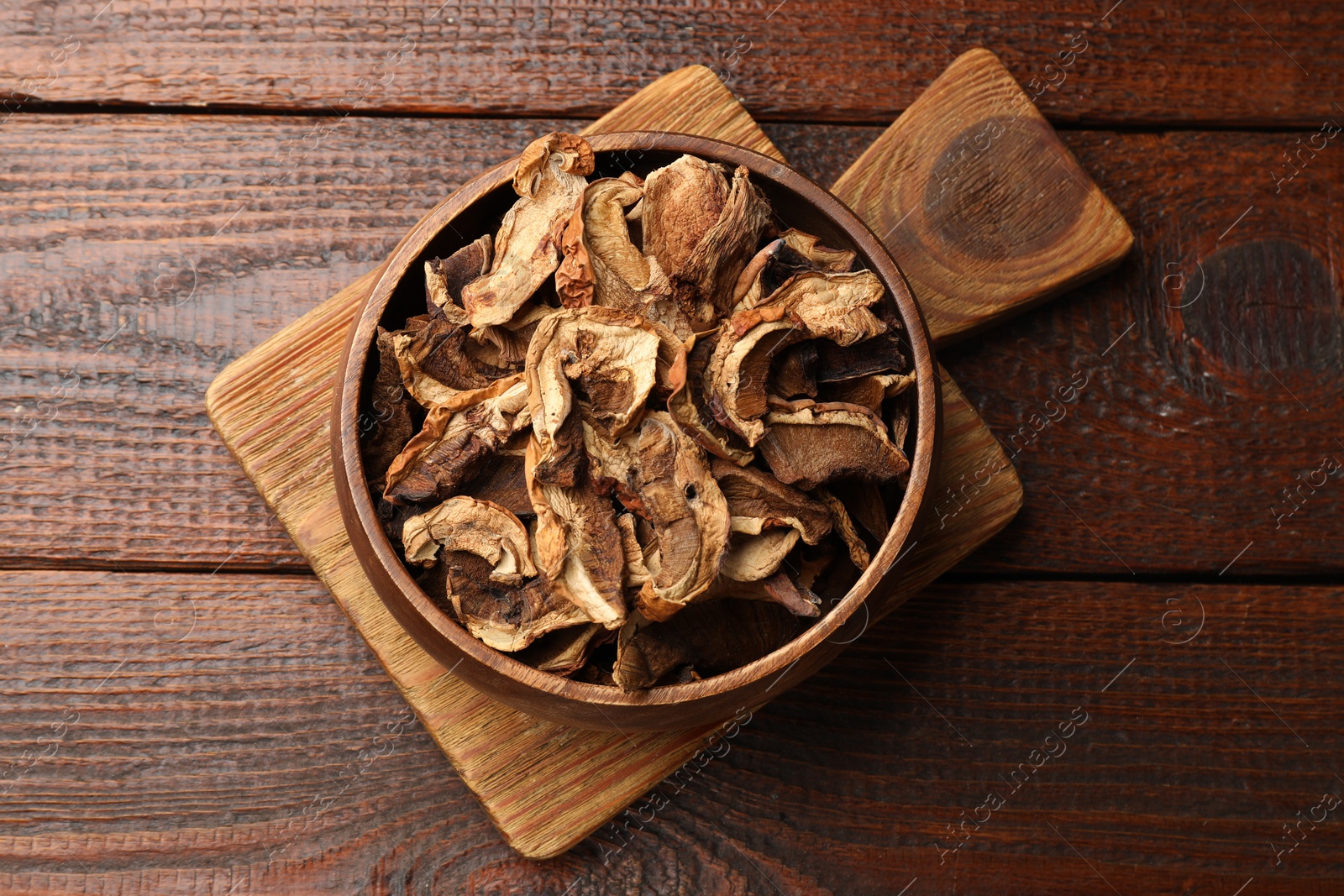 Dried chanterelle mushrooms on wooden table, top view Photo of Dried chanterelle mushrooms on wooden table, top view