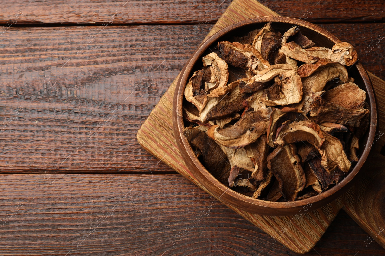 Dried chanterelle mushrooms on wooden table, top view. Space for text Photo of Dried chanterelle mushrooms on wooden table, top view. Space for text