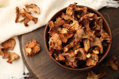 Photo of Dried chanterelle mushrooms on wooden table, flat lay