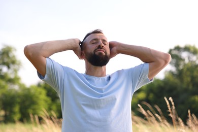 Photo of Feeling freedom. Happy man enjoying time outdoors