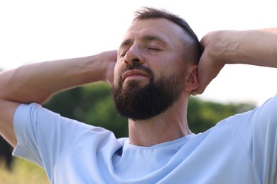 Photo of Feeling freedom. Happy man enjoying time outdoors