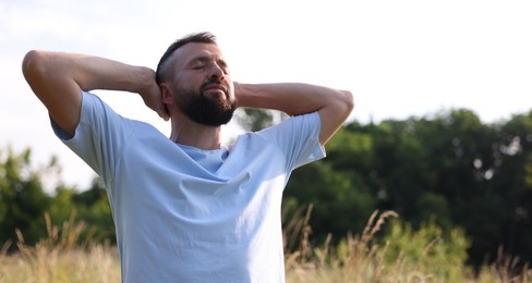 Photo of Feeling freedom. Man enjoying time outdoors. Space for text