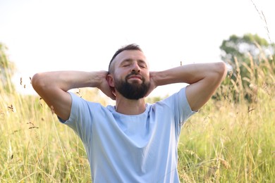 Photo of Feeling freedom. Happy man enjoying time outdoors