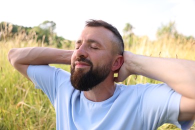 Photo of Feeling freedom. Happy man enjoying time outdoors