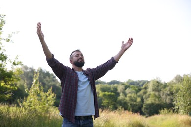Photo of Feeling freedom. Man enjoying time outdoors. Space for text