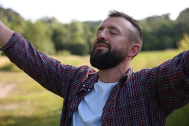 Photo of Feeling freedom. Happy man enjoying time outdoors