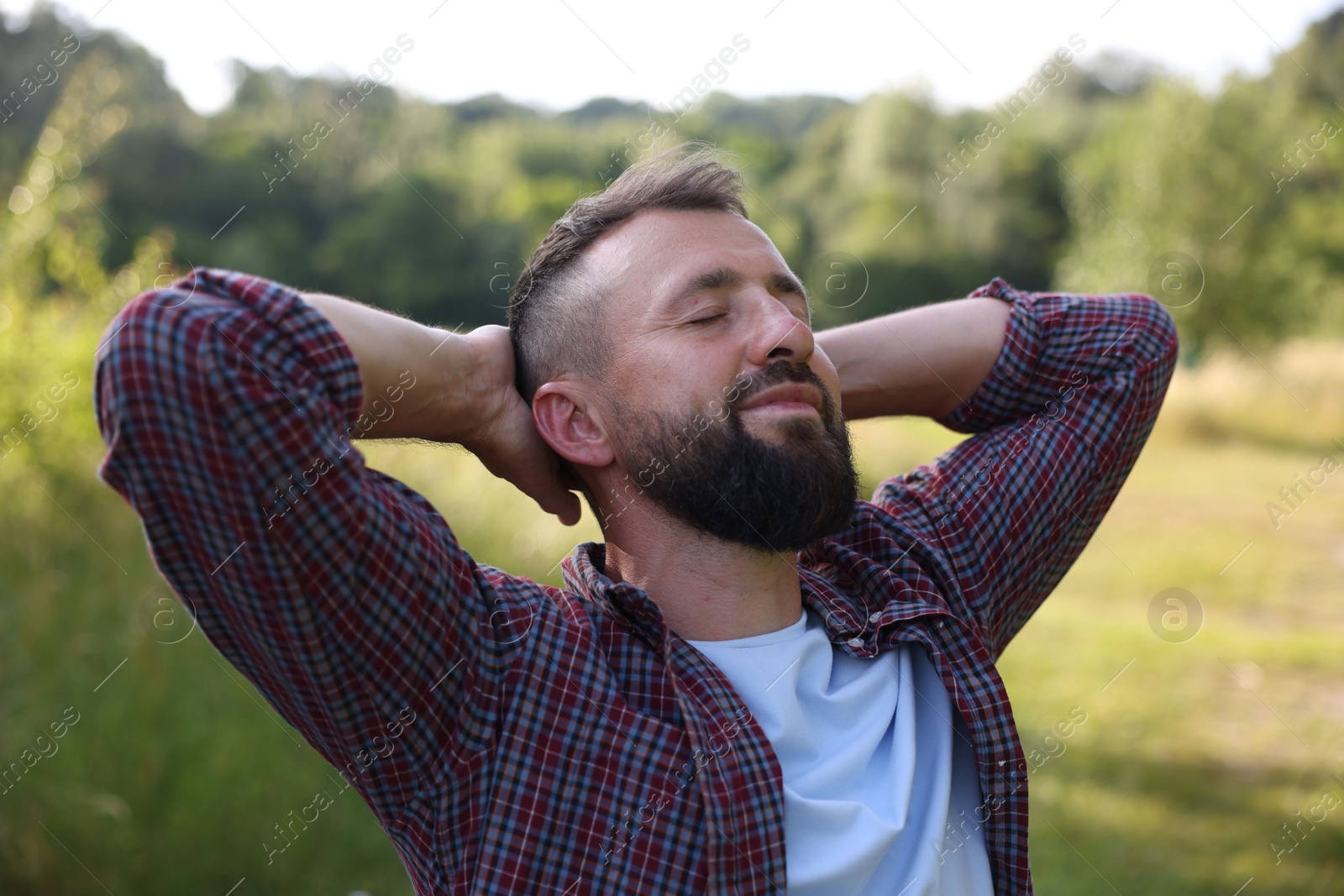 Feeling freedom. Happy man enjoying time outdoors Photo of Feeling freedom. Happy man enjoying time outdoors