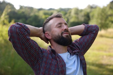 Photo of Feeling freedom. Happy man enjoying time outdoors