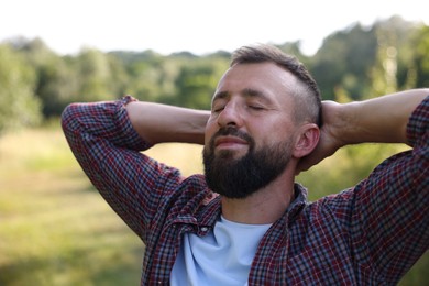 Photo of Feeling freedom. Happy man enjoying time outdoors