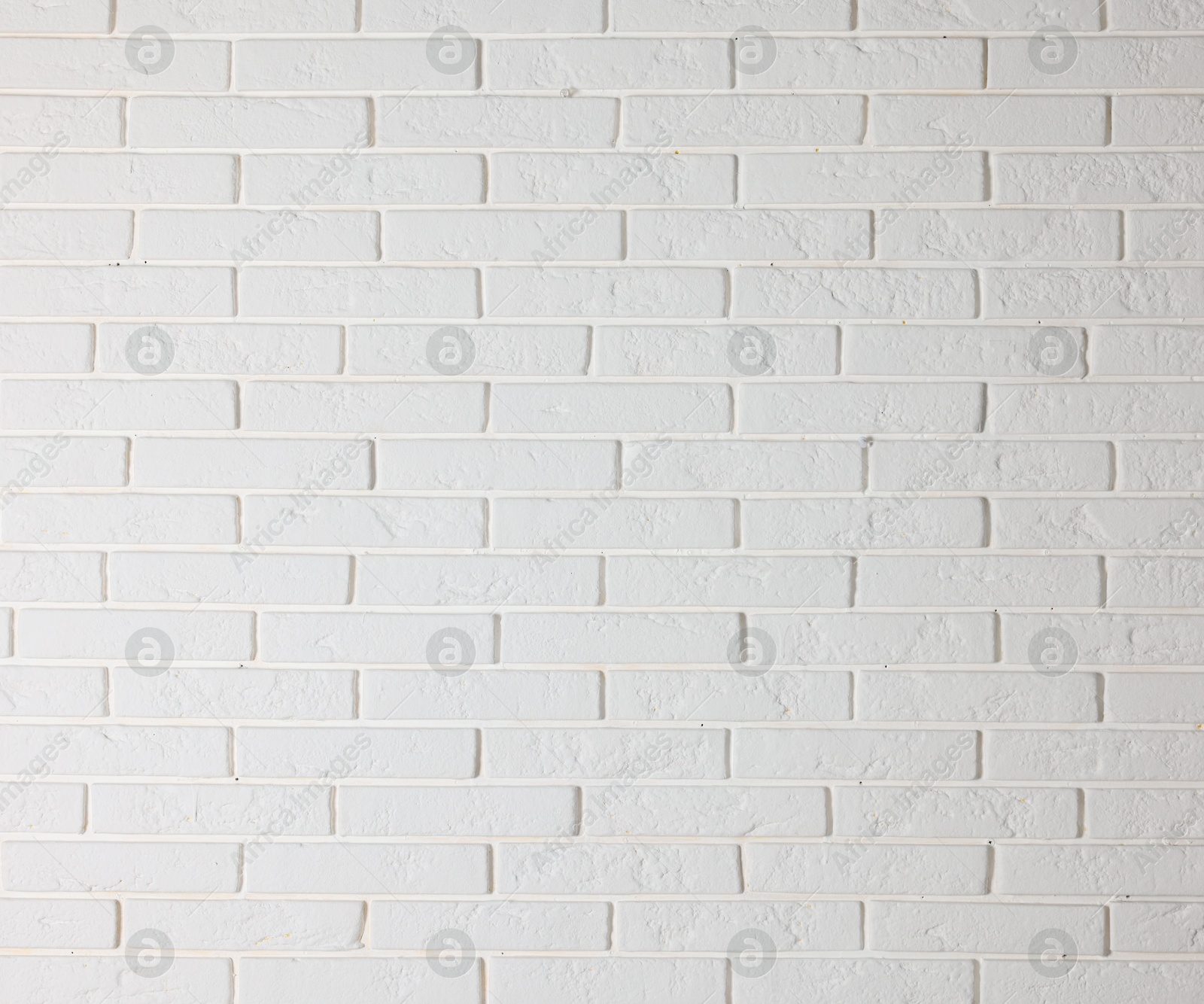 Photo of Texture of white brick wall as background, closeup