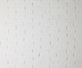 Photo of Texture of white brick wall as background, closeup