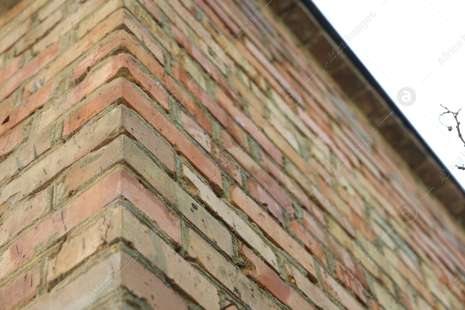 Photo of Building with old red brick walls outdoors, low angle view