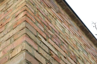 Photo of Building with old red brick walls outdoors, low angle view
