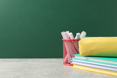Photo of Stylish stationery on light desk against chalkboard. space for text