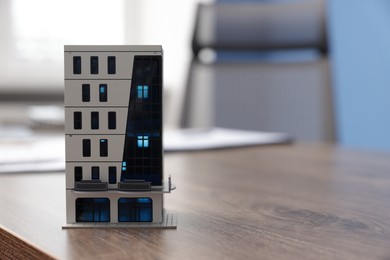 Photo of House model on desk in real estate agent's office, space for text