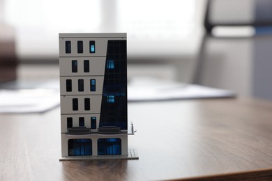Photo of House model on desk in real estate agent's office, space for text