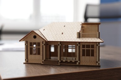Photo of House model on desk in real estate agent's office, closeup