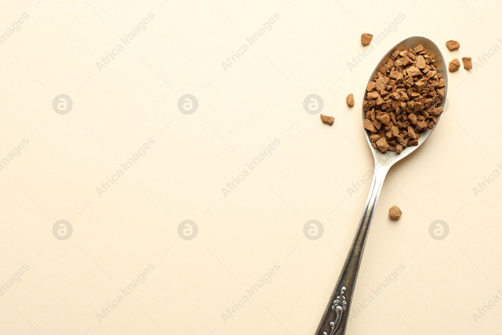 Spoon with instant coffee on beige background, top view. Space for text Photo of Spoon with instant coffee on beige background, top view. Space for text