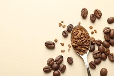 Photo of Spoon with instant coffee and beans on beige background, flat lay. Space for text