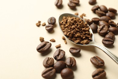 Photo of Spoon with instant coffee and beans on beige background, closeup. Space for text
