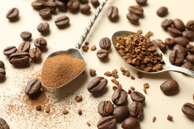 Photo of Spoons with instant coffee and beans on beige background, closeup