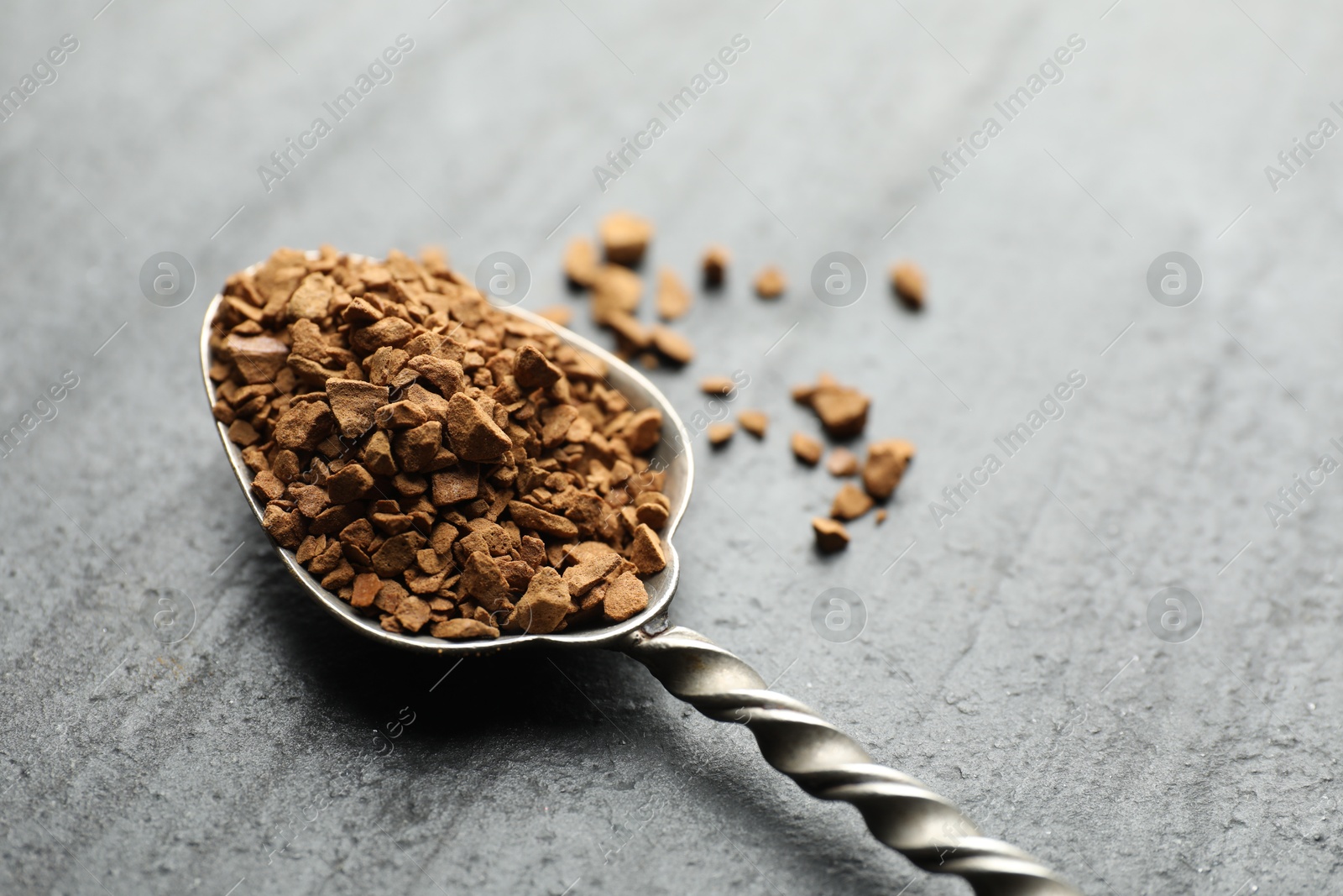 Spoon with instant coffee on black table, closeup. Space for text Photo of Spoon with instant coffee on black table, closeup. Space for text