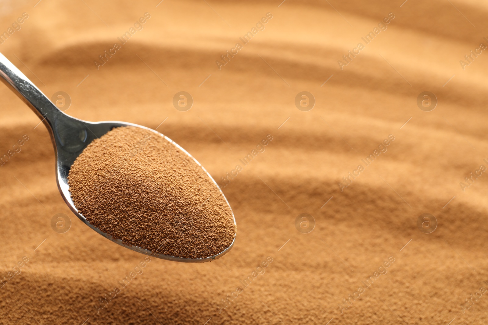 Spoon with aromatic instant coffee as background, closeup Photo of Spoon with aromatic instant coffee as background, closeup