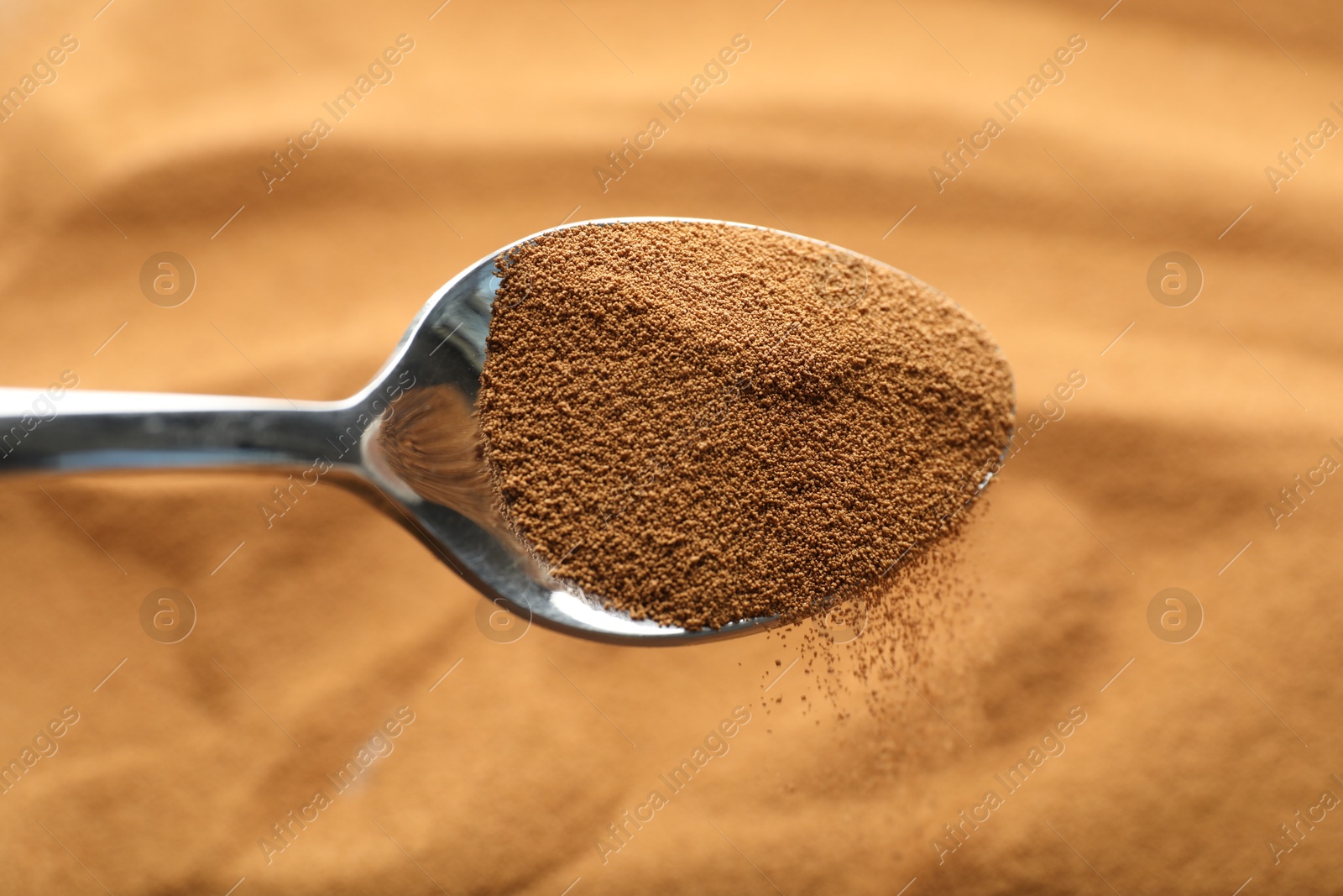 Spoon with aromatic instant coffee as background, closeup Photo of Spoon with aromatic instant coffee as background, closeup