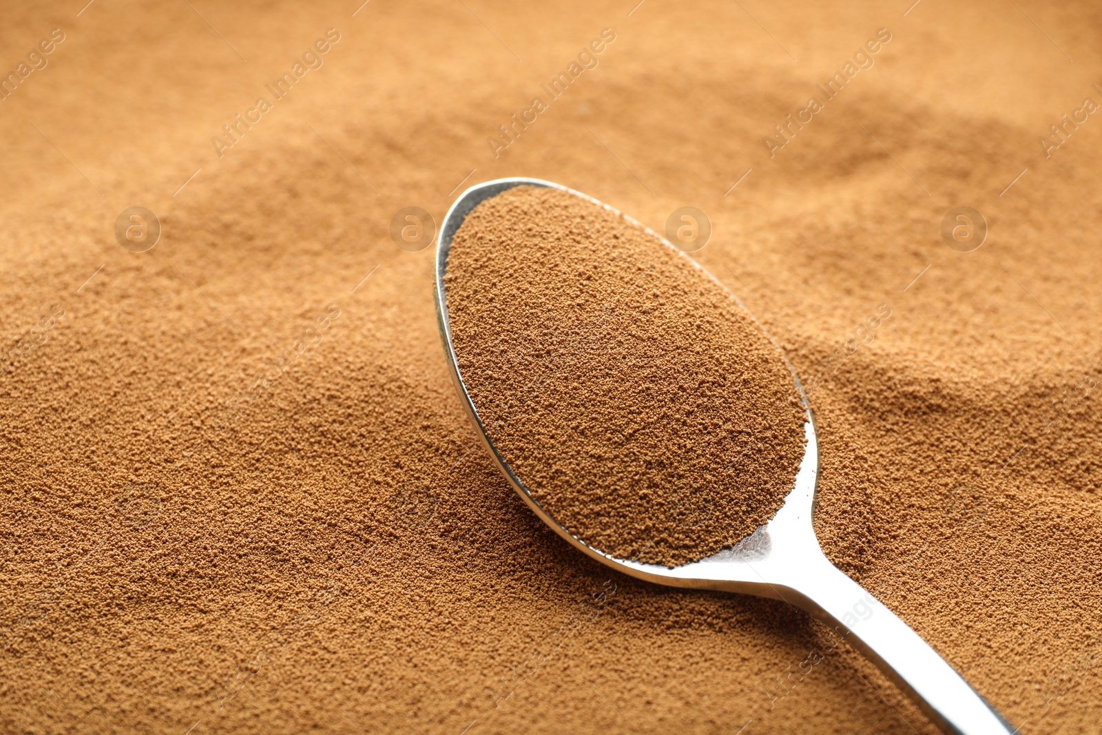 Spoon with aromatic instant coffee as background, closeup Photo of Spoon with aromatic instant coffee as background, closeup