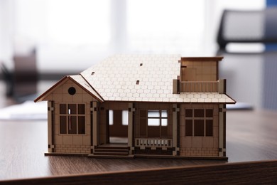 Photo of House model on desk in real estate agent's office, closeup