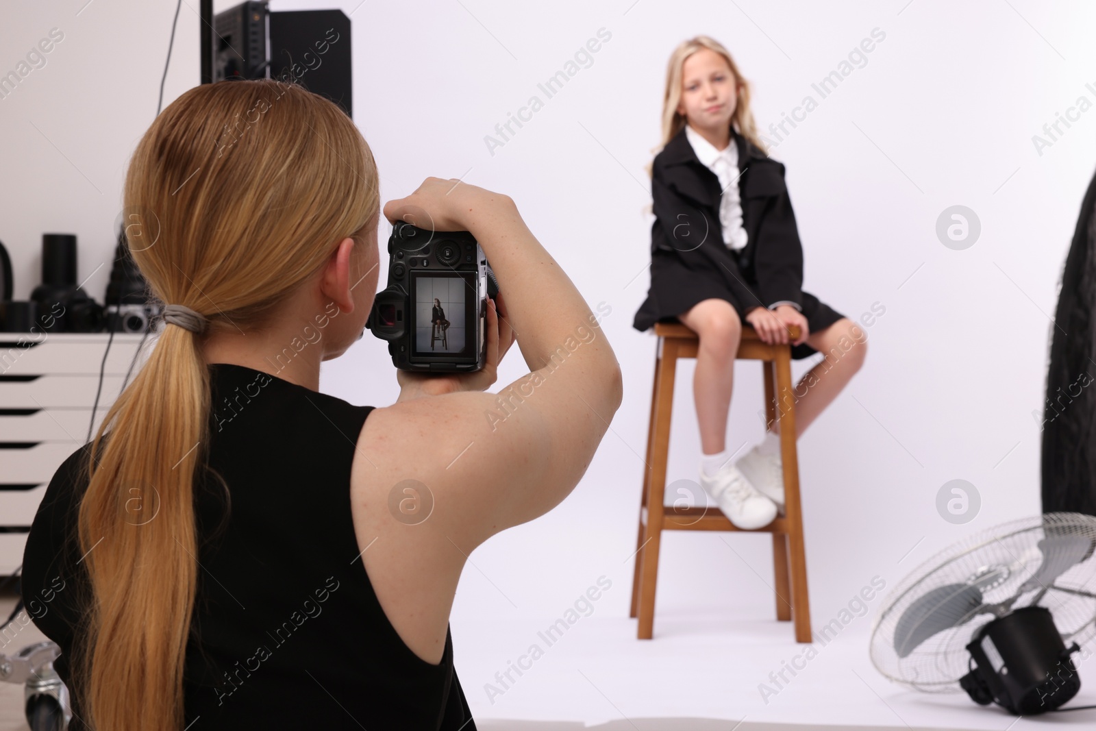 Photographer working with model in professional photo studio, selective focus Photo of Photographer working with model in professional photo studio, selective focus