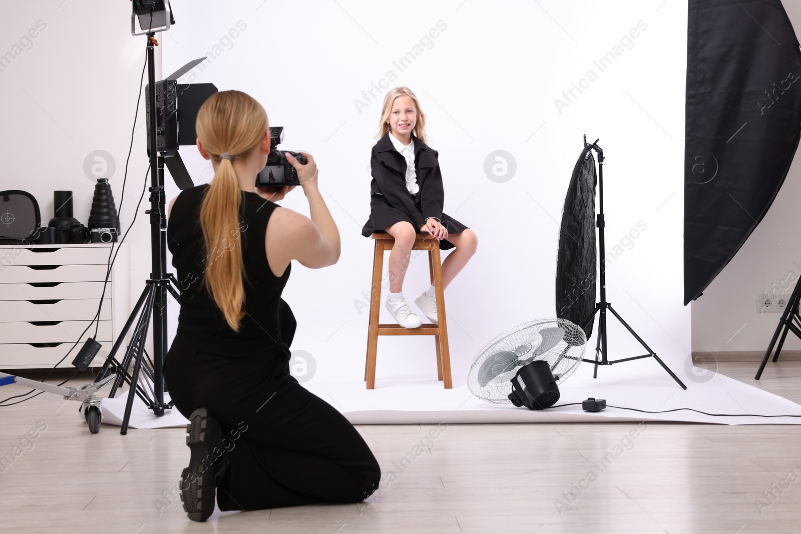 Photo of Photographer working with model in professional photo studio