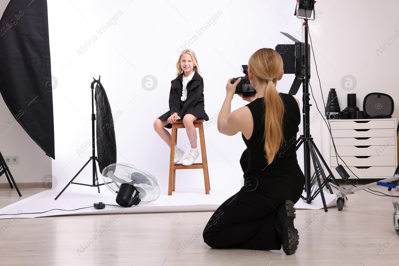 Photographer working with model in professional photo studio Photo of Photographer working with model in professional photo studio