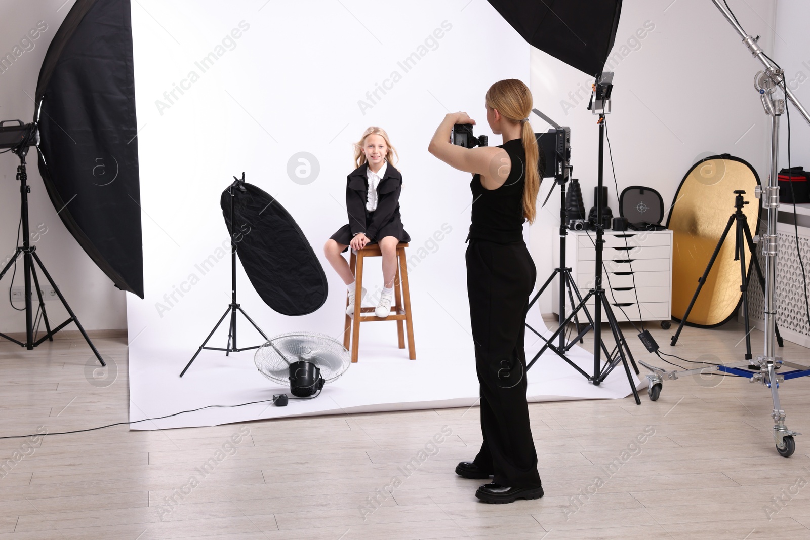 Photographer working with model in professional photo studio Photo of Photographer working with model in professional photo studio