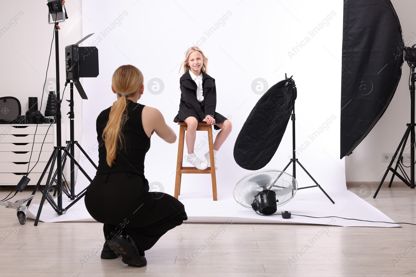 Photographer working with model in professional photo studio Photo of Photographer working with model in professional photo studio