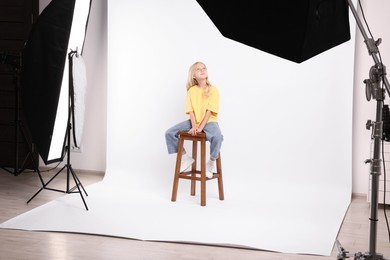 Photo of Little girl on white background in photo studio with professional equipment