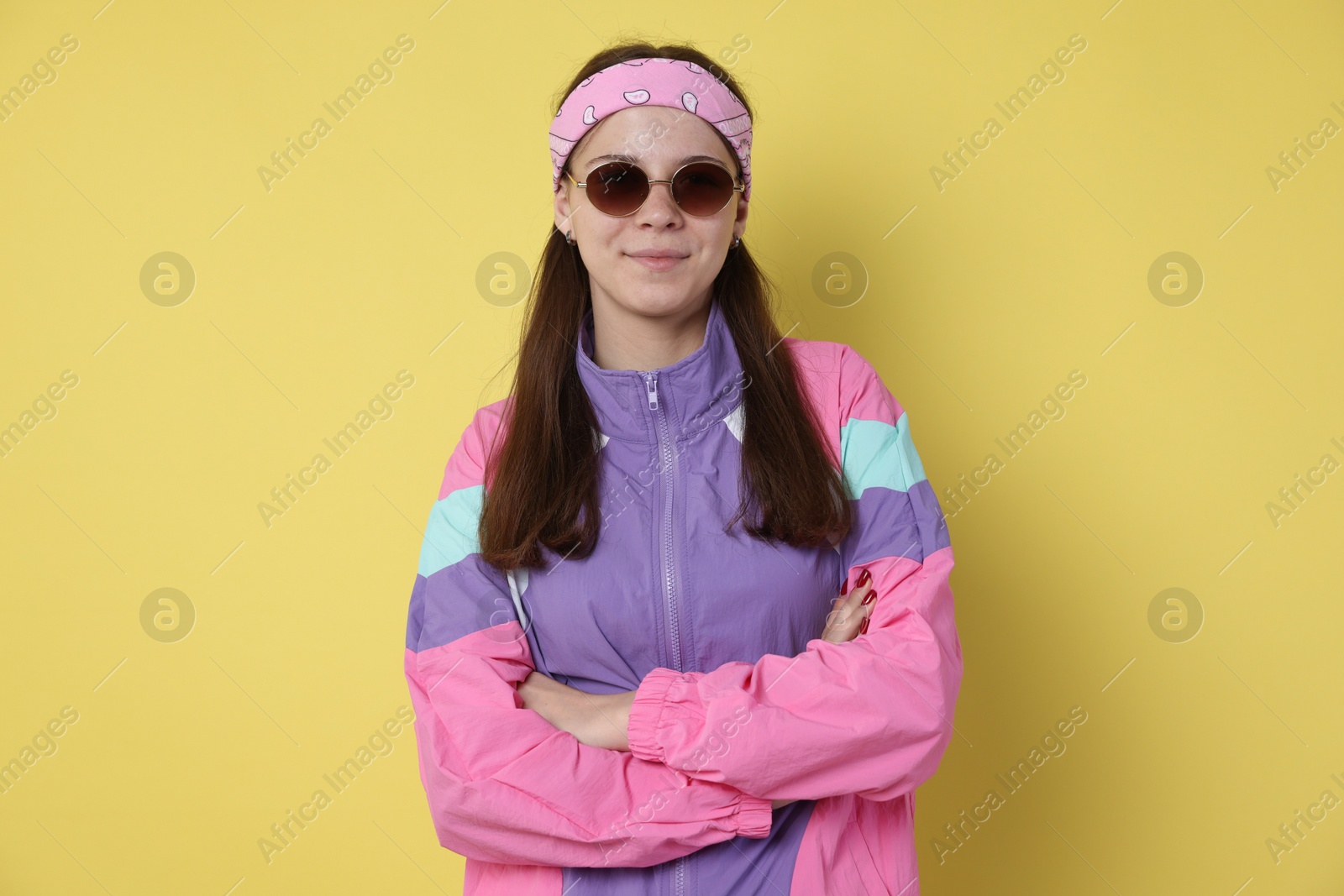Teenage girl in sunglasses on yellow background Photo of Teenage girl in sunglasses on yellow background